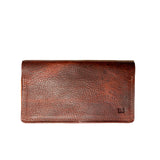 A brown Rogue Industries leather checkbook cover on a white background, crafted in a Maine workshop.