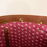 The Sheepscot Felt Wool Tote Bag by Rogue Industries features a luxurious brown leather interior, complemented by a pink lining adorned with an enchanting white moose pattern and accented with refined leather trim for added sophistication.