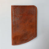 A Rogue Industries Chamberlain Belt and Minimalist Wallet Bundle in brown leather on a white surface.