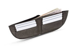 A black Nantucket Front Pocket Wallet by Rogue Industries with money in it.