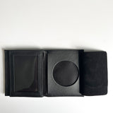 A black Rogue Industries Leather Badge Holder Wallet with a black coin inside, designed as a badge holder for first responders.