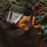 A durable, brown Rogue Industries waxed canvas tote bag with top-grain leather straps.