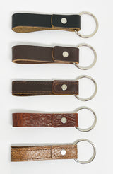 Four durable Rogue Industries leather key chains in different colors, each with a nickel rivet.