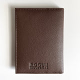A Rogue Industries brown leather passport holder with the word "focus" monogrammed on it.